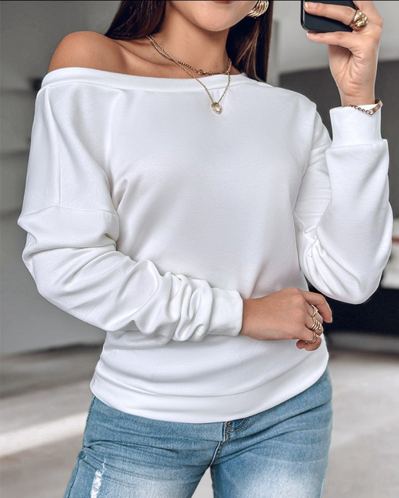 Solid color long sleeve top with open back and metal buttons