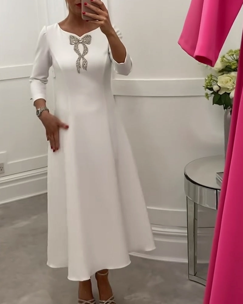 Elegant, plain dress with bow and three-quarter sleeves