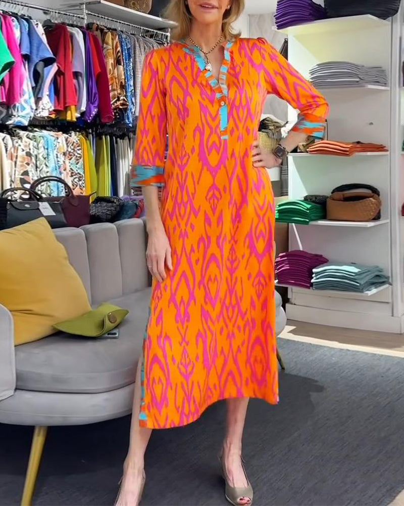 Elegant printed dress with v-neck, three-quarter sleeves and slit