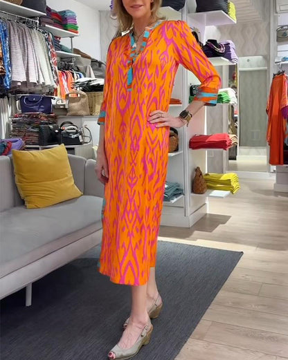 Elegant printed dress with v-neck, three-quarter sleeves and slit