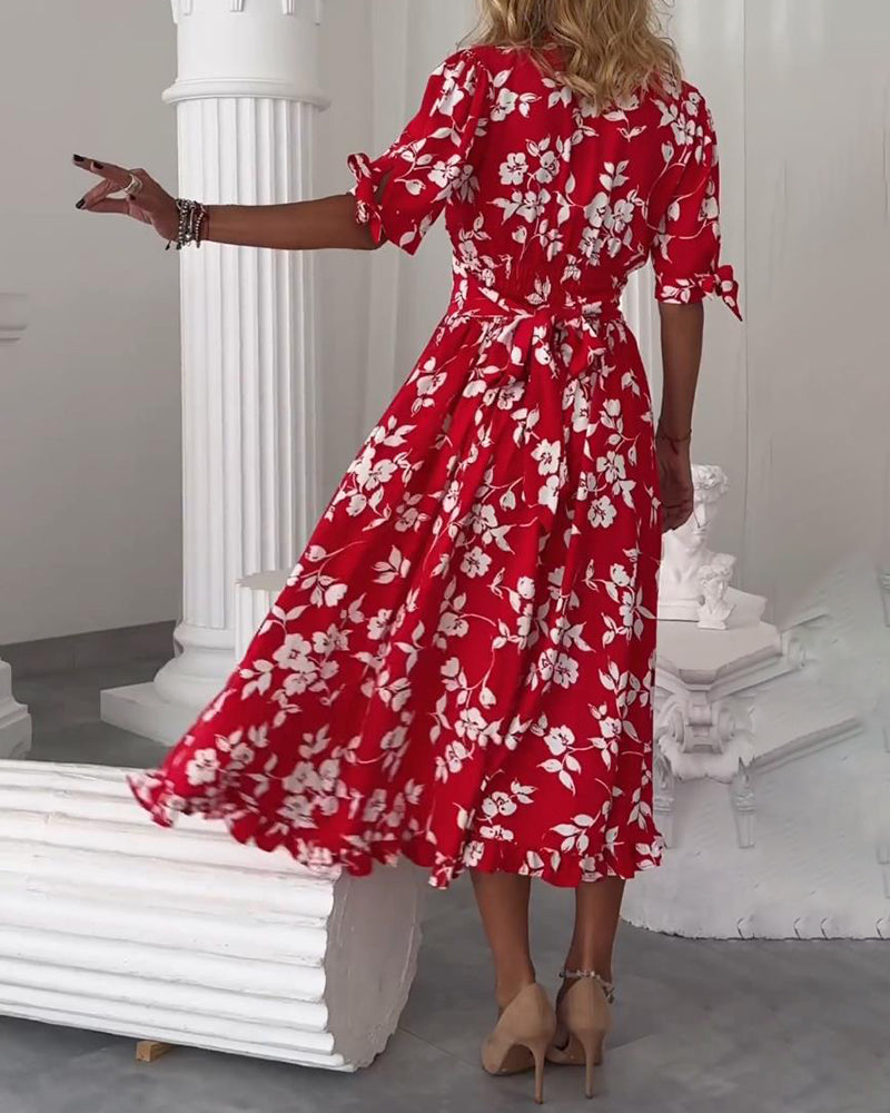 Vestido elegante com padrão floral e laço nos punhos